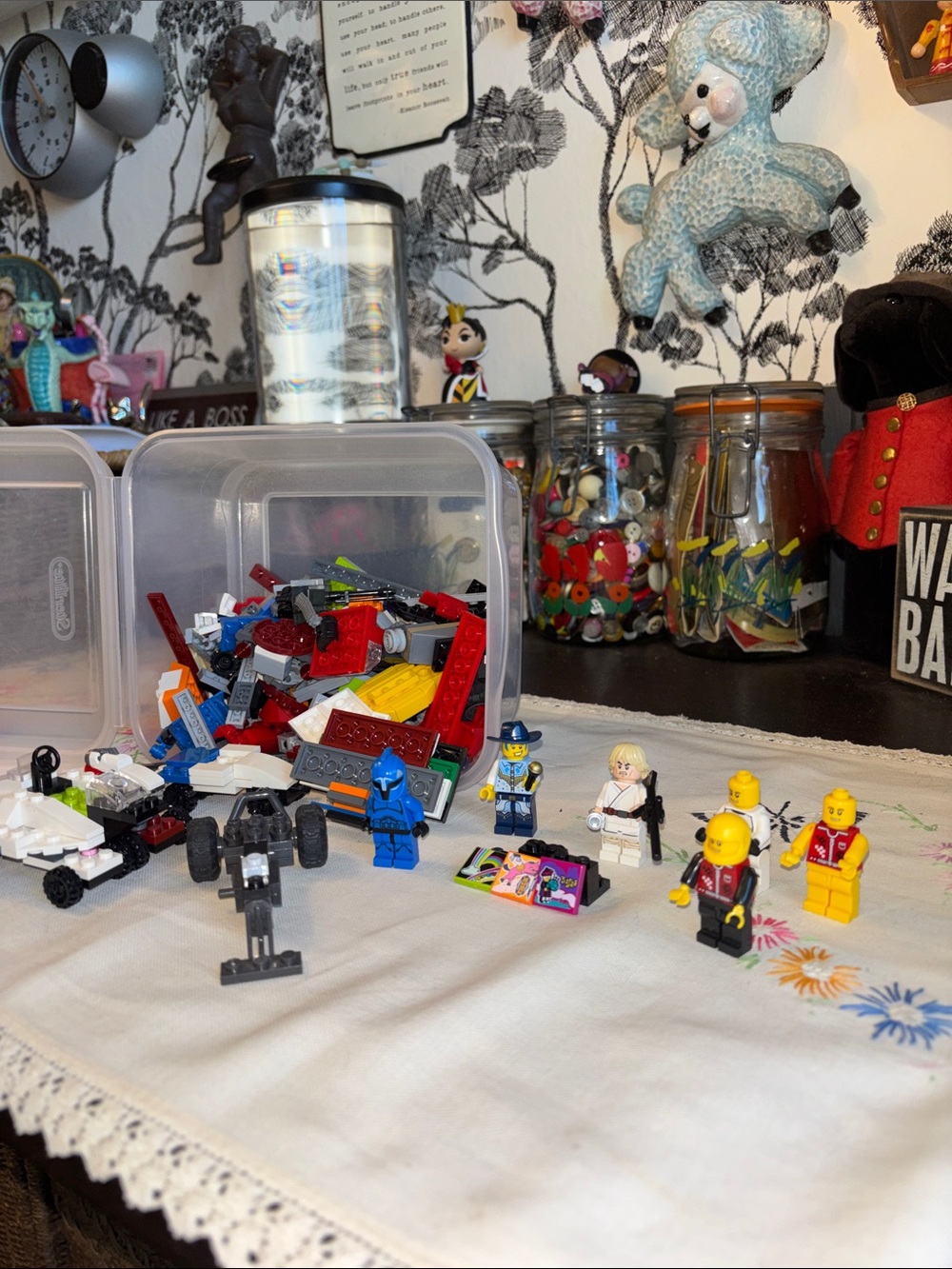 EUC collection of mixed LEGO minifigures and parts laid out on a white tableclot